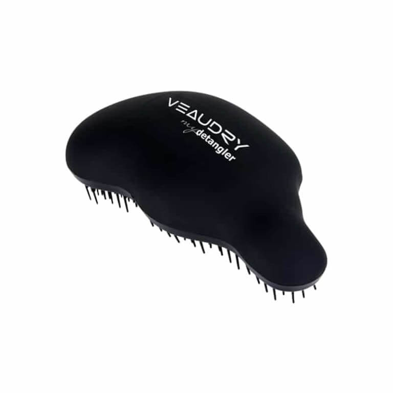 A black veaudry hair brush with white text.