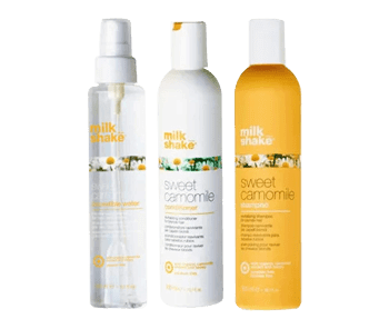 Three bottles of milk and honey hair care products.
