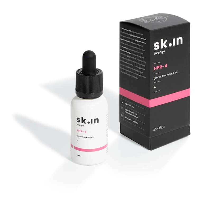 A bottle of skinn cbd oil with a box next to it.
