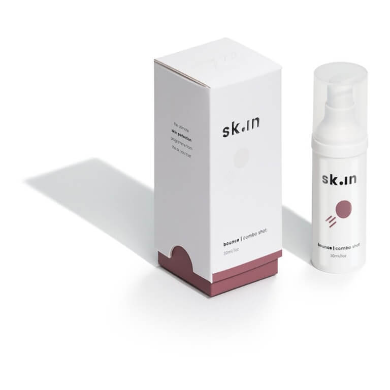 A bottle of skun serum next to a box.