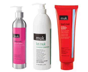 Three bottles of mulk hair care products on a black background.