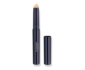 The Dr. Hauschka concealer stick is shown on a white background.