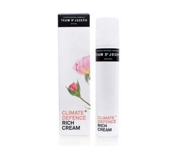 A tube of climate rich cream with a rose on it.