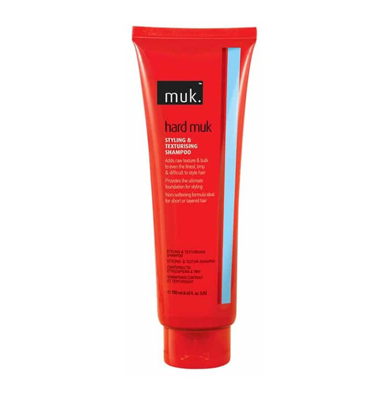 A tube of moisturizing cream on a white background with Hard muk styling shampoo.