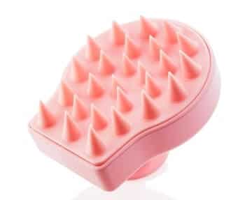 A pink hair brush with spikes on it.