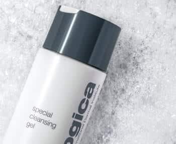 A bottle of Dermalogica facial cleansing gel sitting on top of snow.