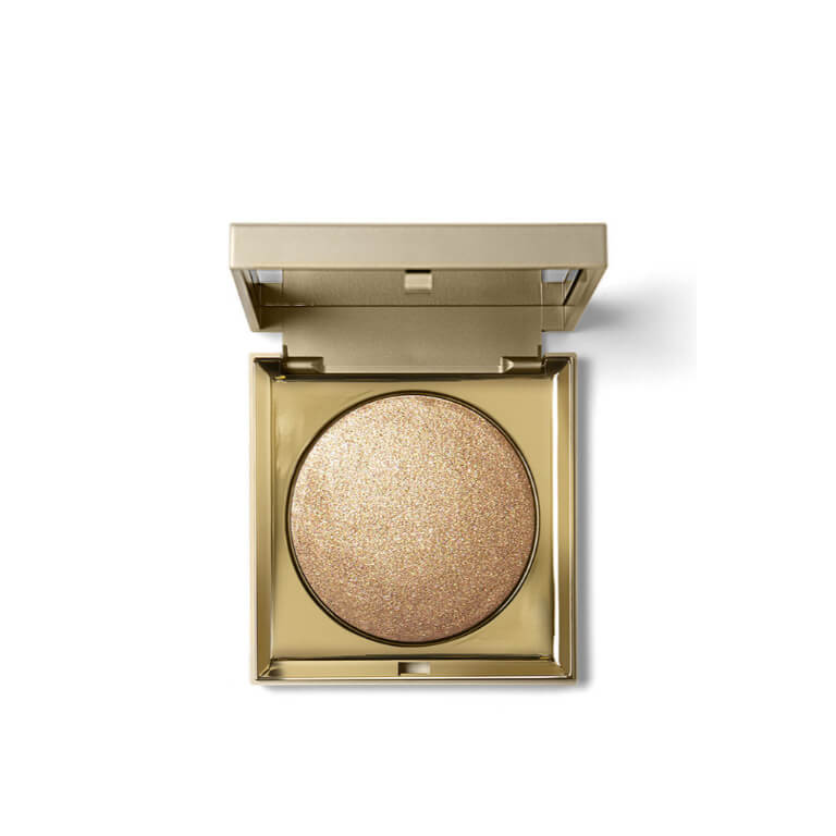 A gold-plated Stila- Heaven's Hue Highlighter Bronze on a white background.