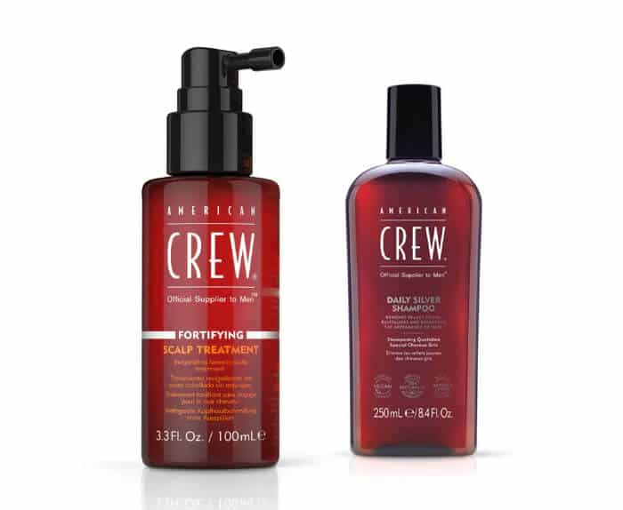 Two bottles of crew hair care products on a white background.