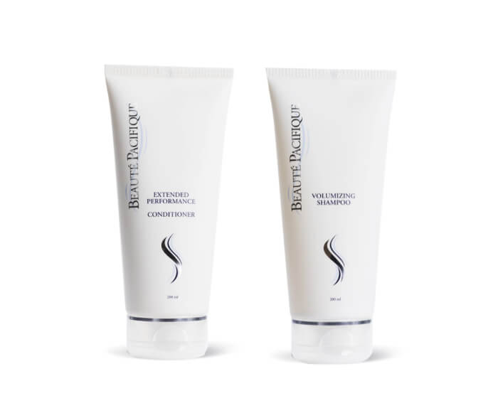 Two tubes of hair care products on a white background.