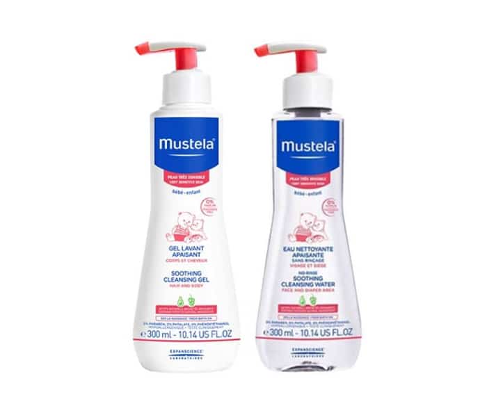 Two bottles of mustel baby lotion on a white background.